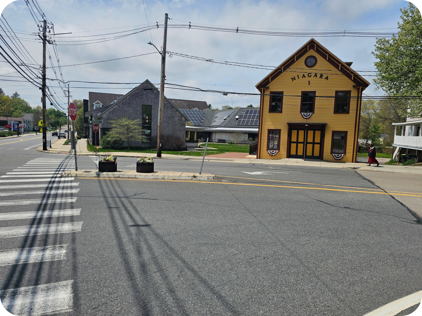 Complete Streets project in Millis, MA, including raised pedestrian refuge islands, a crosswalk, and other compliant infrastructure