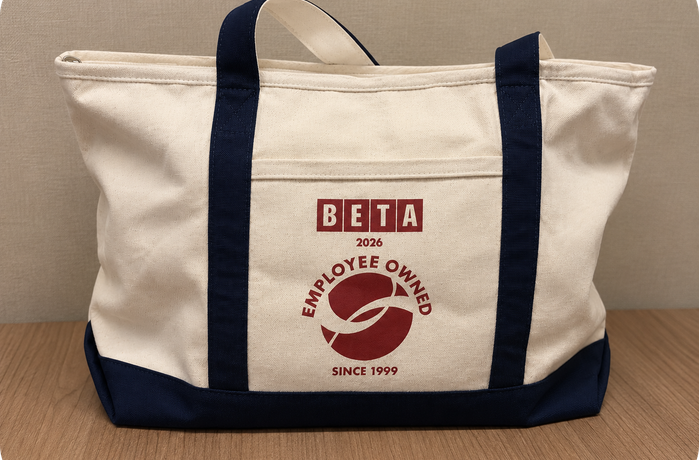 A tote bag with a BETA Employee Ownership logo
